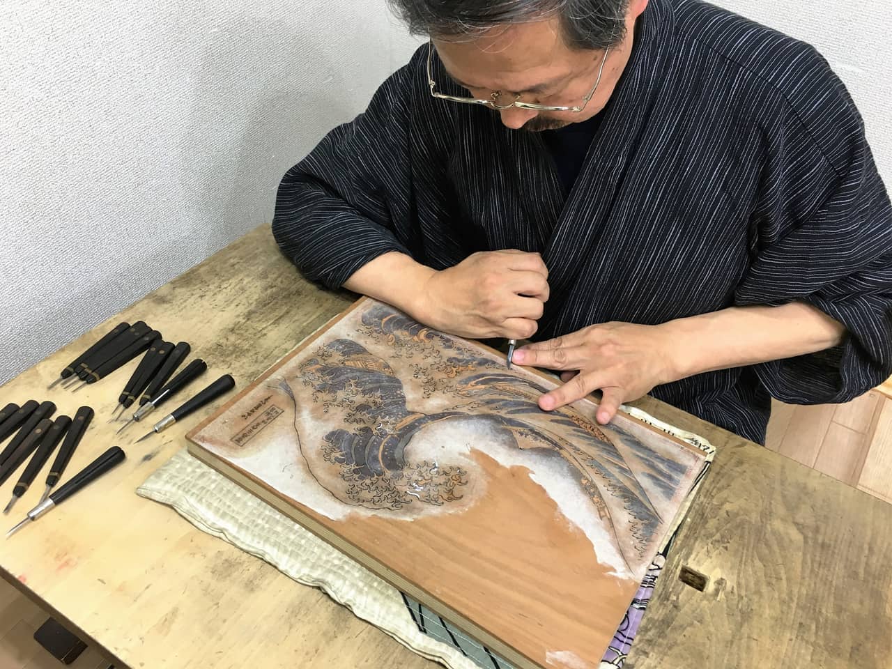 The original ink drawing is glued to the wood panel, then engraved.